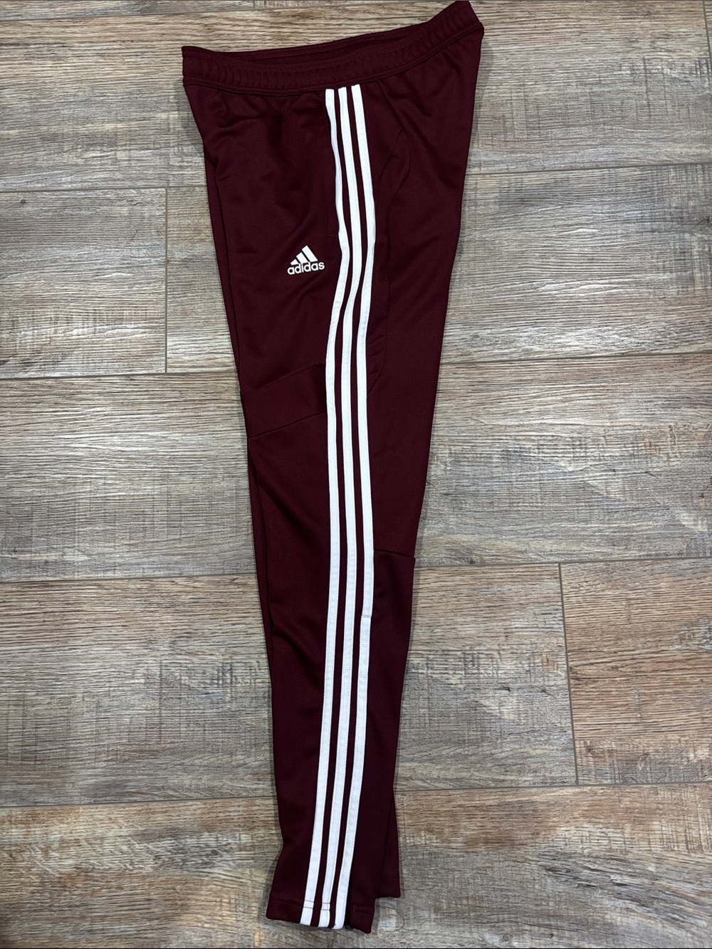 Adidas women’s tiro pants, maroon/white. Size Small.